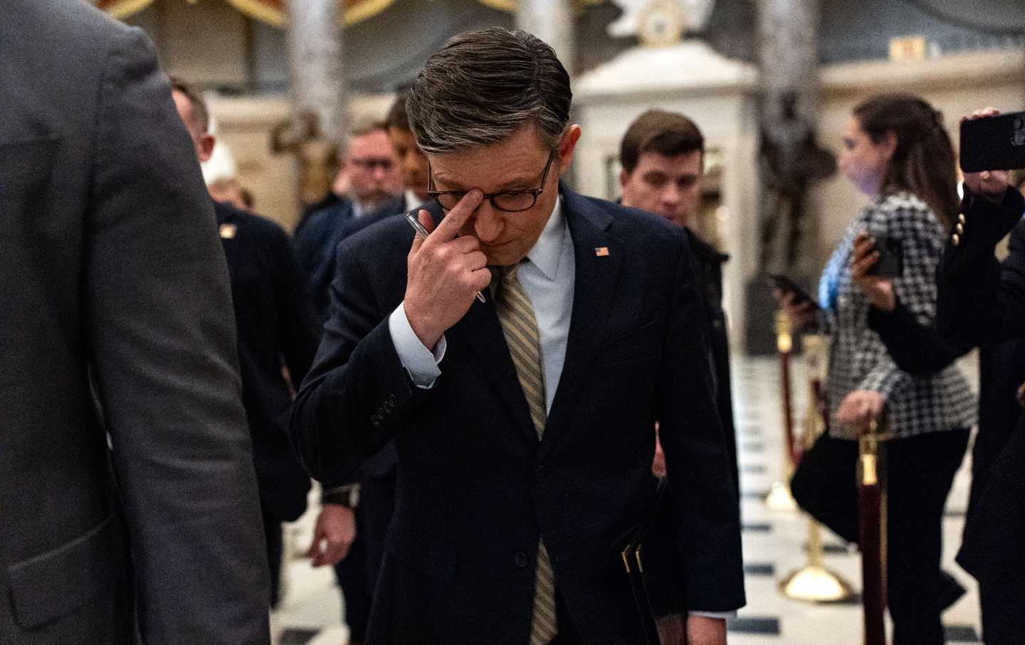 US Speaker of the House Mike Johnson paces just prior to the House's approval of a stopgap spending bill.