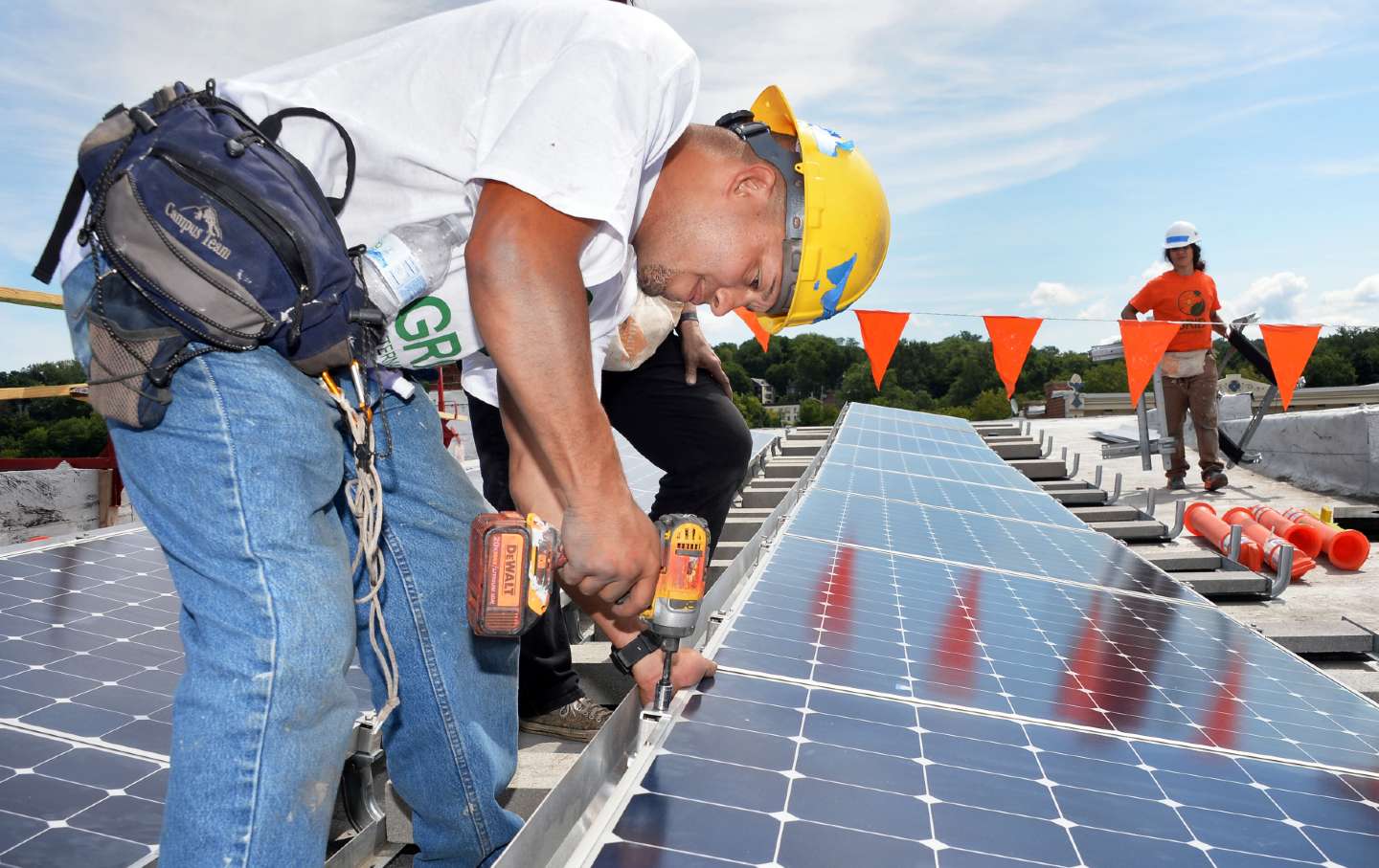 Shane Velez of the Bronx installs a solar electric system panel in Tory, New York, on August 7, 2015.