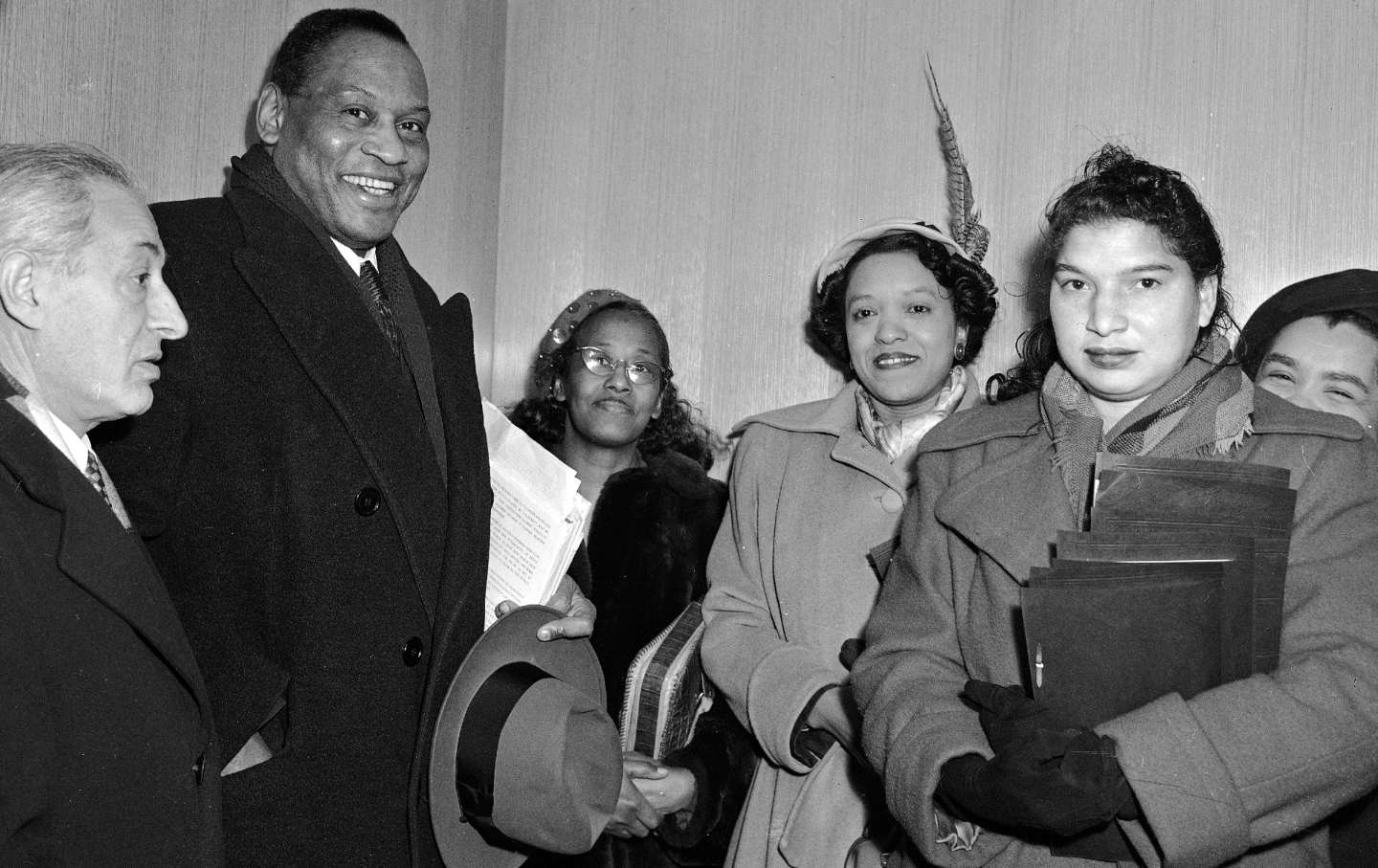 Paul Robeson and unidentified members of a delegation sponsored by the Civil Rights Congress wait in United Nations headquarters to be taken to the offices of Special Service Division Acting Direcor William M. Agar, December 17, 1951, where they will present the "We Charge Genocide" petition against the US government.