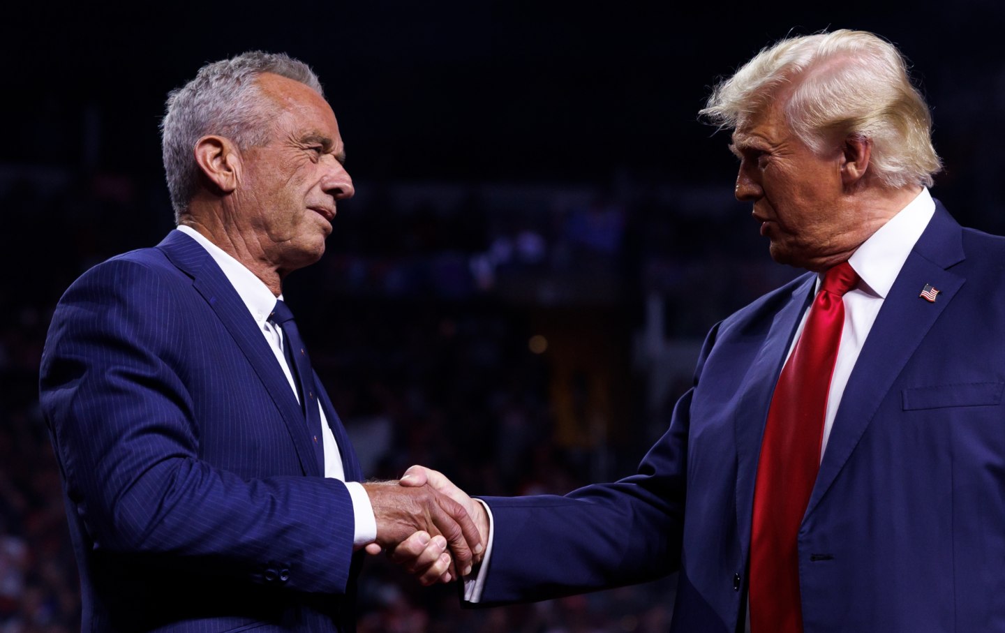 Donald Trump is greeted by Robert F. Kennedy Jr. on stage during a campaign event at Desert Diamond Arena in Glendale, Arizona, on August 23, 2024.