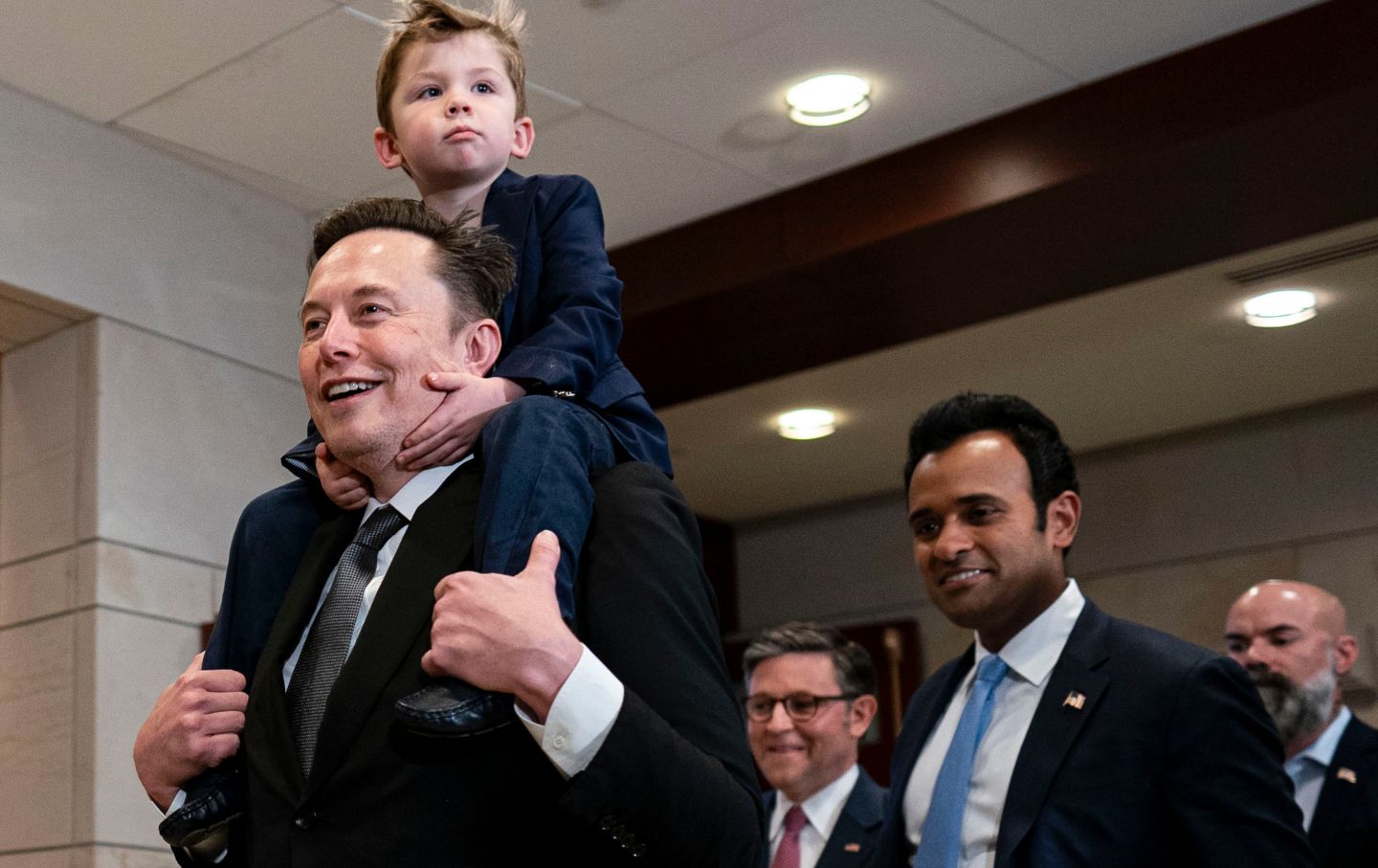 Elon Musk, House Speaker Mike Johnson and Vivek Ramaswamy arrive for a meeting at the Capitol on December 5, 2024.