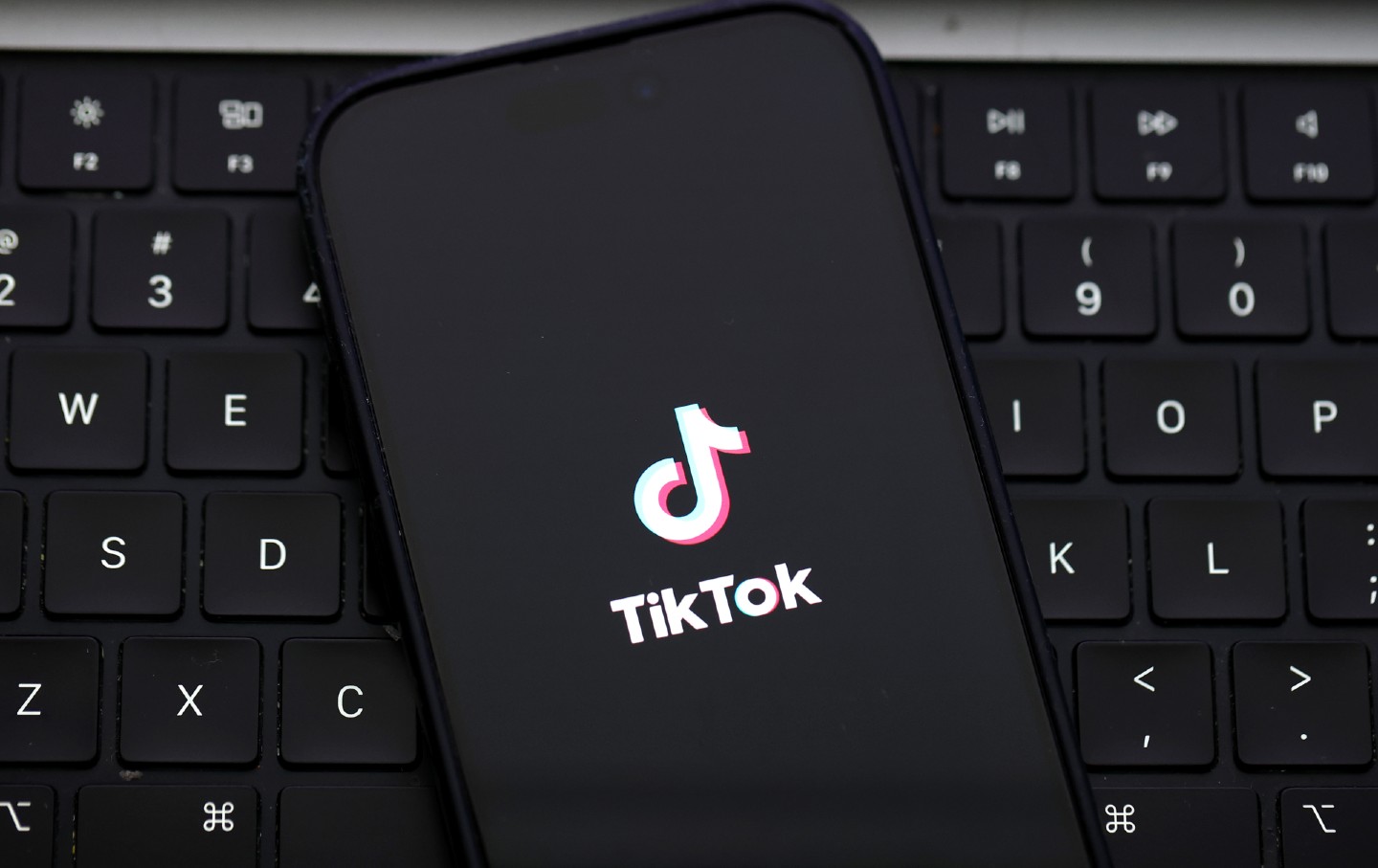 In this photo illustration, the TikTok logo is displayed on an iPhone screen.