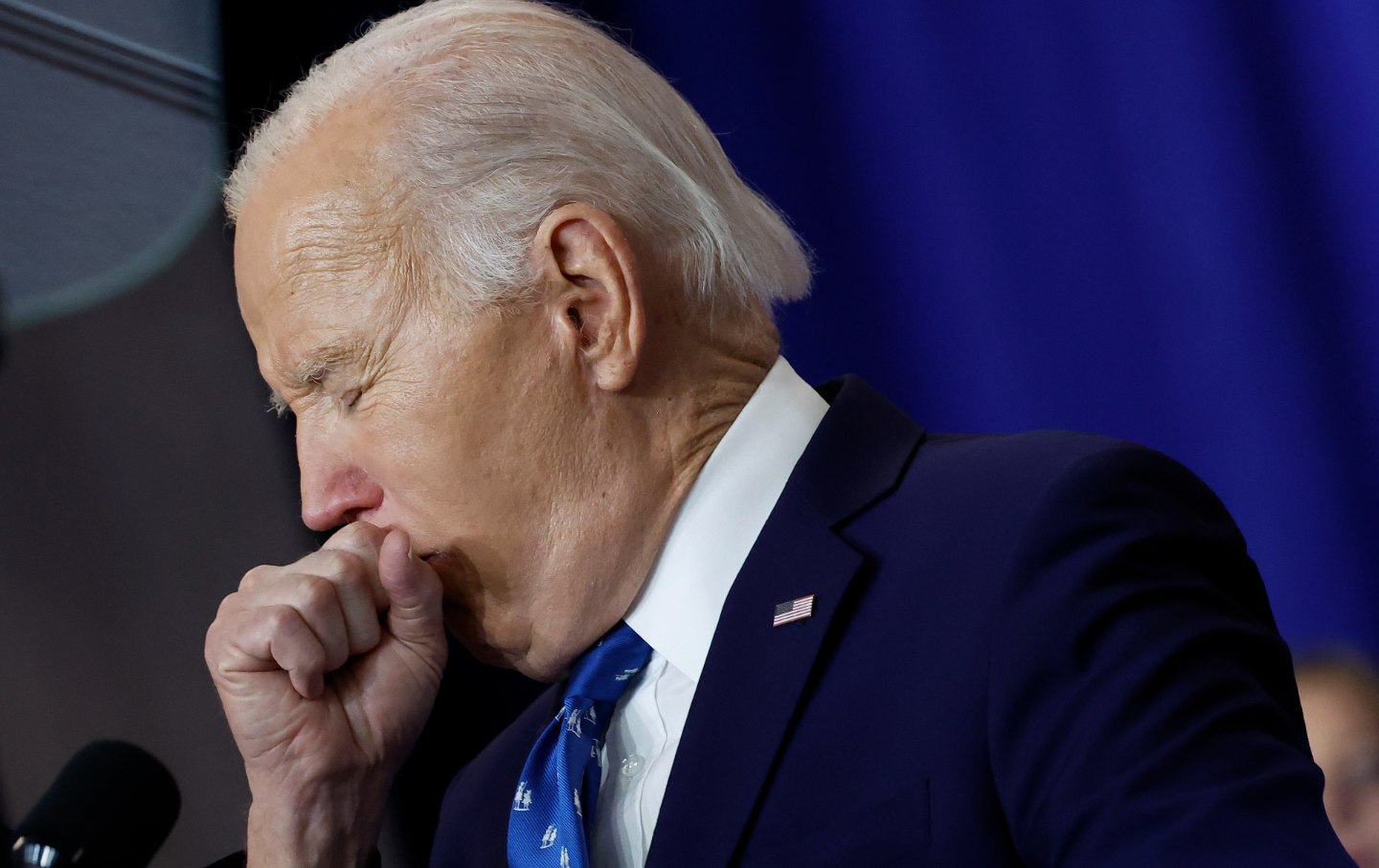 Joe Biden coughs as he delivers remarks at the Department of Labor on December 16, 2024.