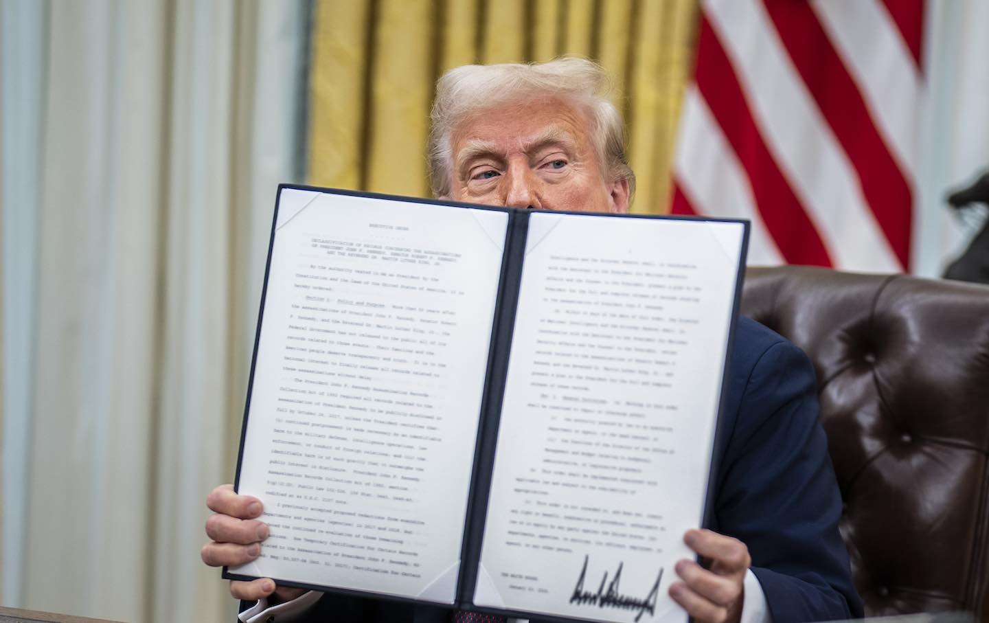 President Donald Trump in the Oval Office at the White House on January 23, 2025, in Washington, DC, shows a signed executive order.