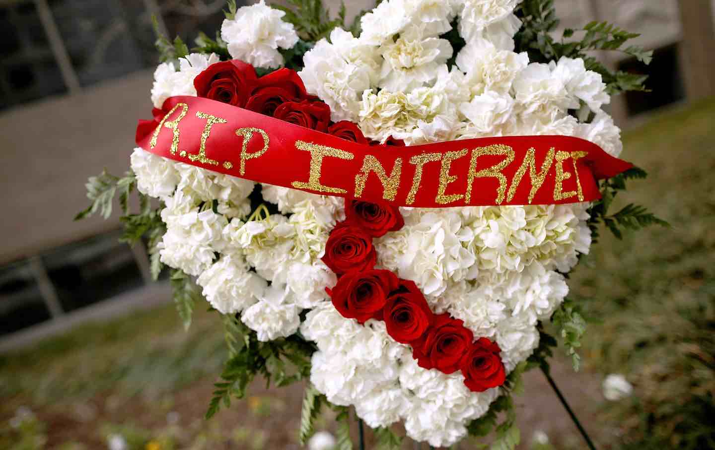 A funeral flower arrangement is placed outside the Federal Communications Commission building during a protest against the repeal of net neutrality rules on December 14, 2017. in Washington, DC.