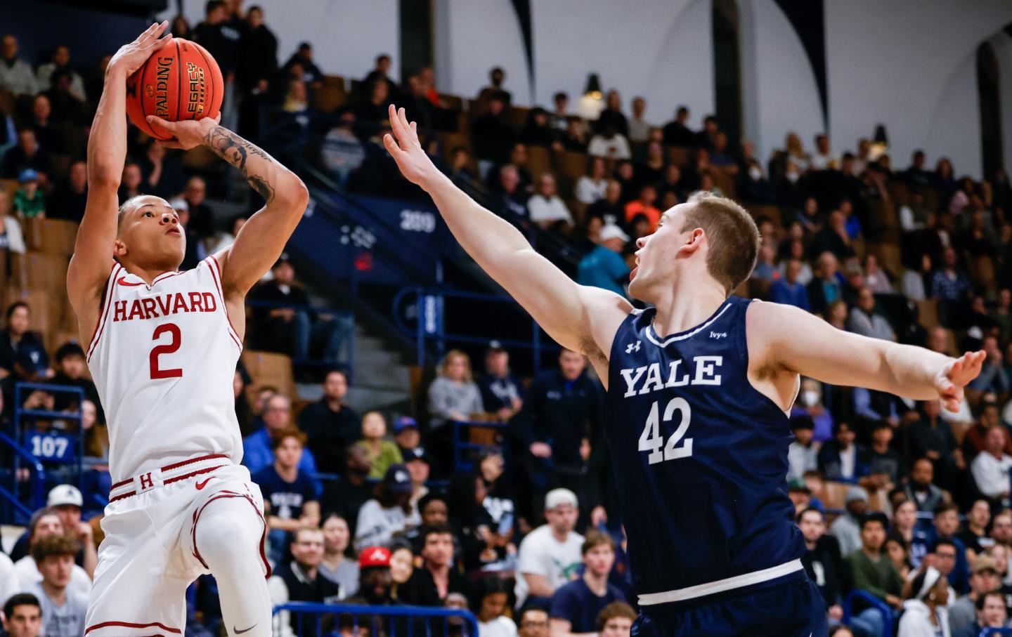 Harvard guard Malik Mack shoots past Yale forward Nick Townsend during an NCAA men’s basketball game in 2024.