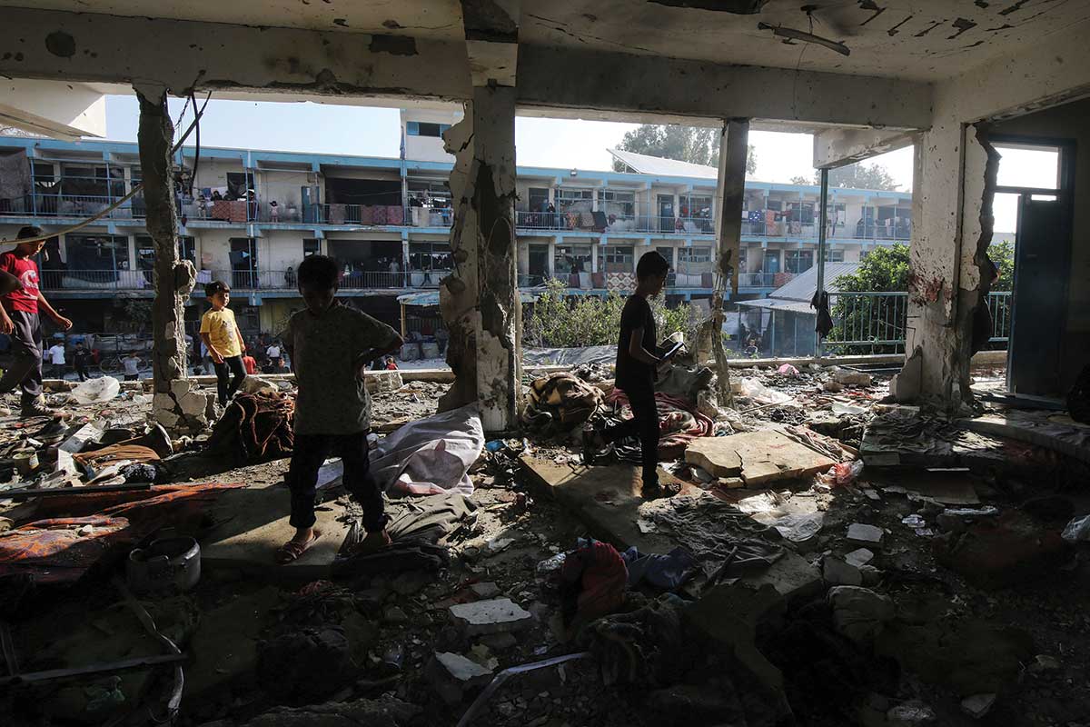 Palestinians inspect the damage dome by an American-made bomb to a school in the Nuseirat refugeee camp in June 2024.