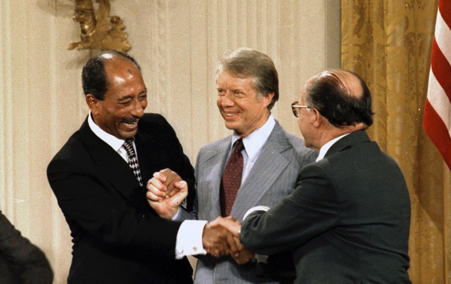 Egyptian President Anwar Sadat, United states President Jimmy Carter and Israeli Prime Minister Meacham Begin, celebrate after signing the Camp David Peace Accords in 1978.