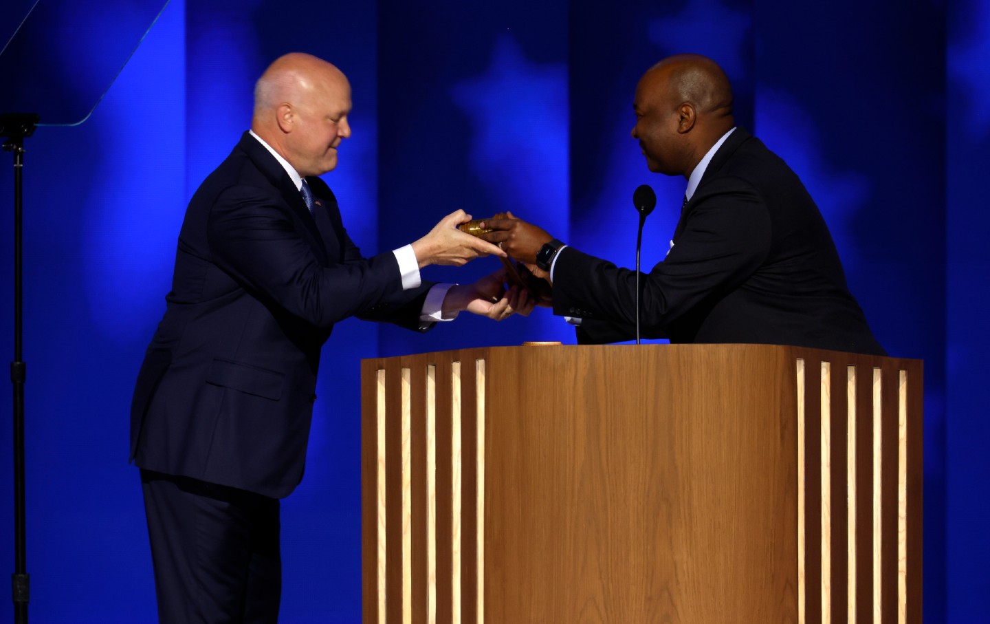 Jaime Harrison, chairman of the Democratic National Committee, hands the gavel to Mitch Landrieu, Democratic National Convention Committee cochair, during the second day of the Democratic National Convention at the United Center on August 20, 2024, in Chicago.