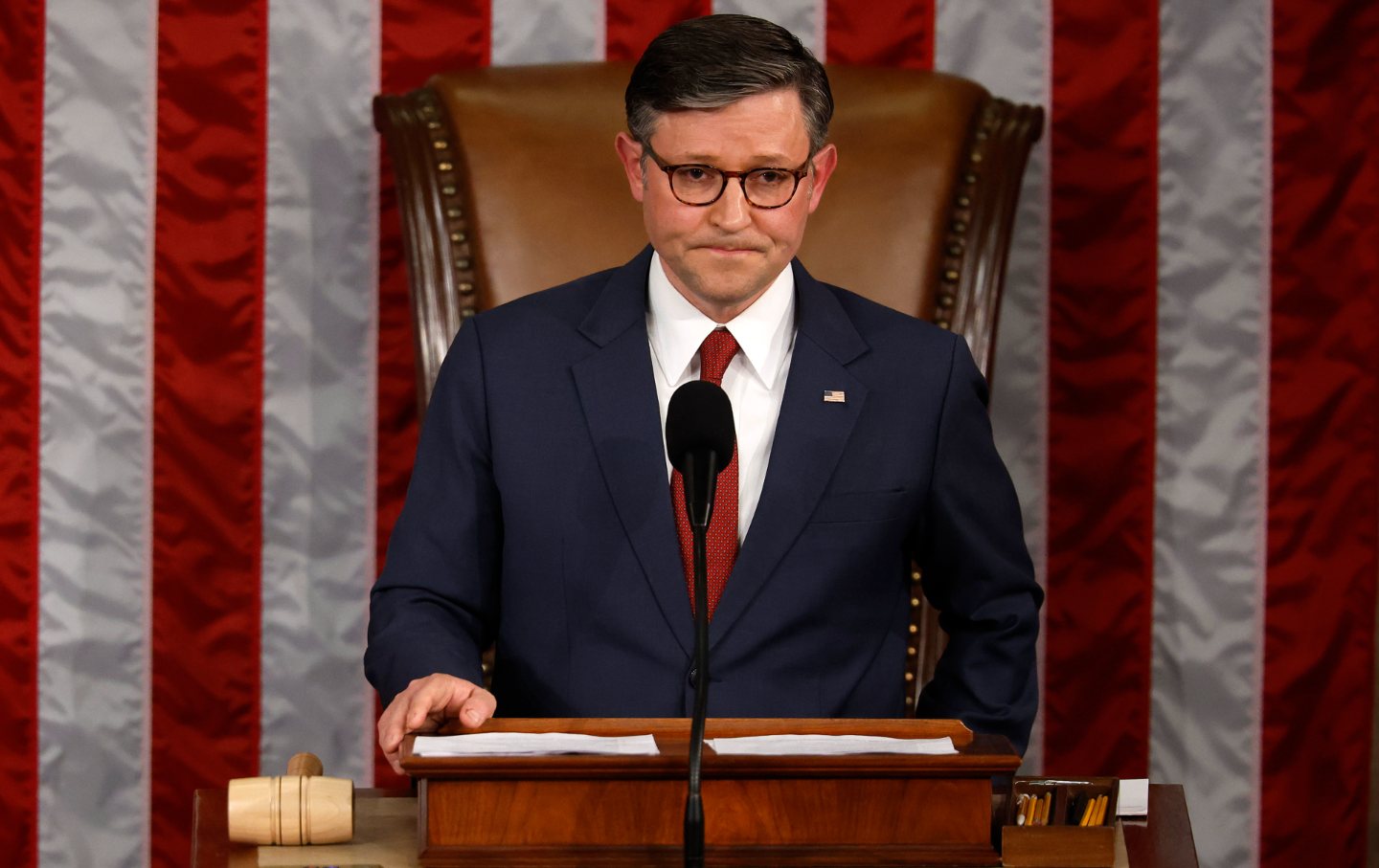 House Speaker Mike Johnson at the podium with a gavel.