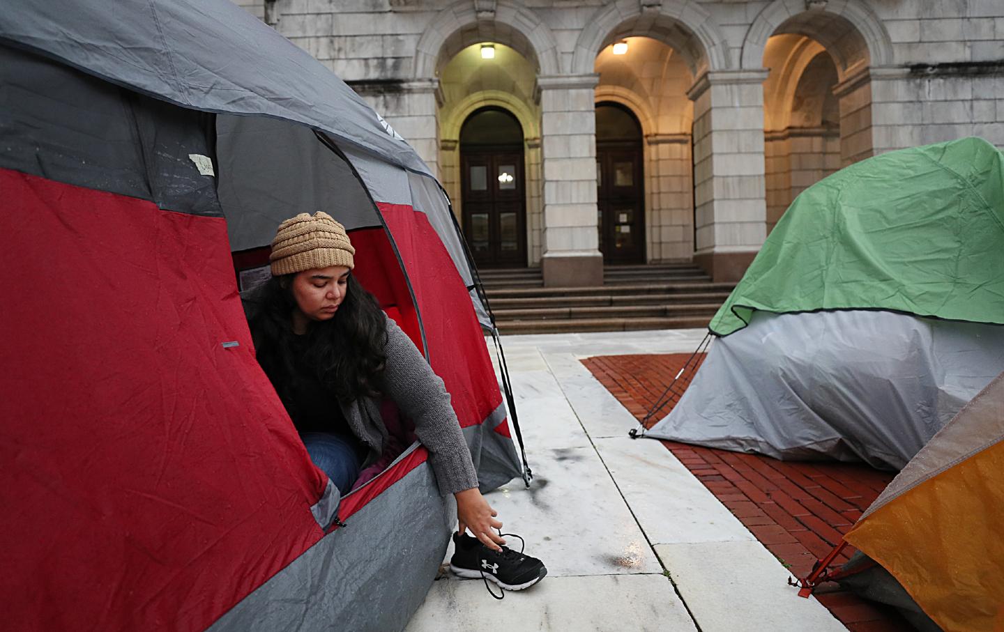 Rhode Island state Senator Cynthia Mendes woke up from her sixth straight night of sleeping in a tent at the Rhode Island Statehouse in Providence, Rhode Island, on December 6, 2021.