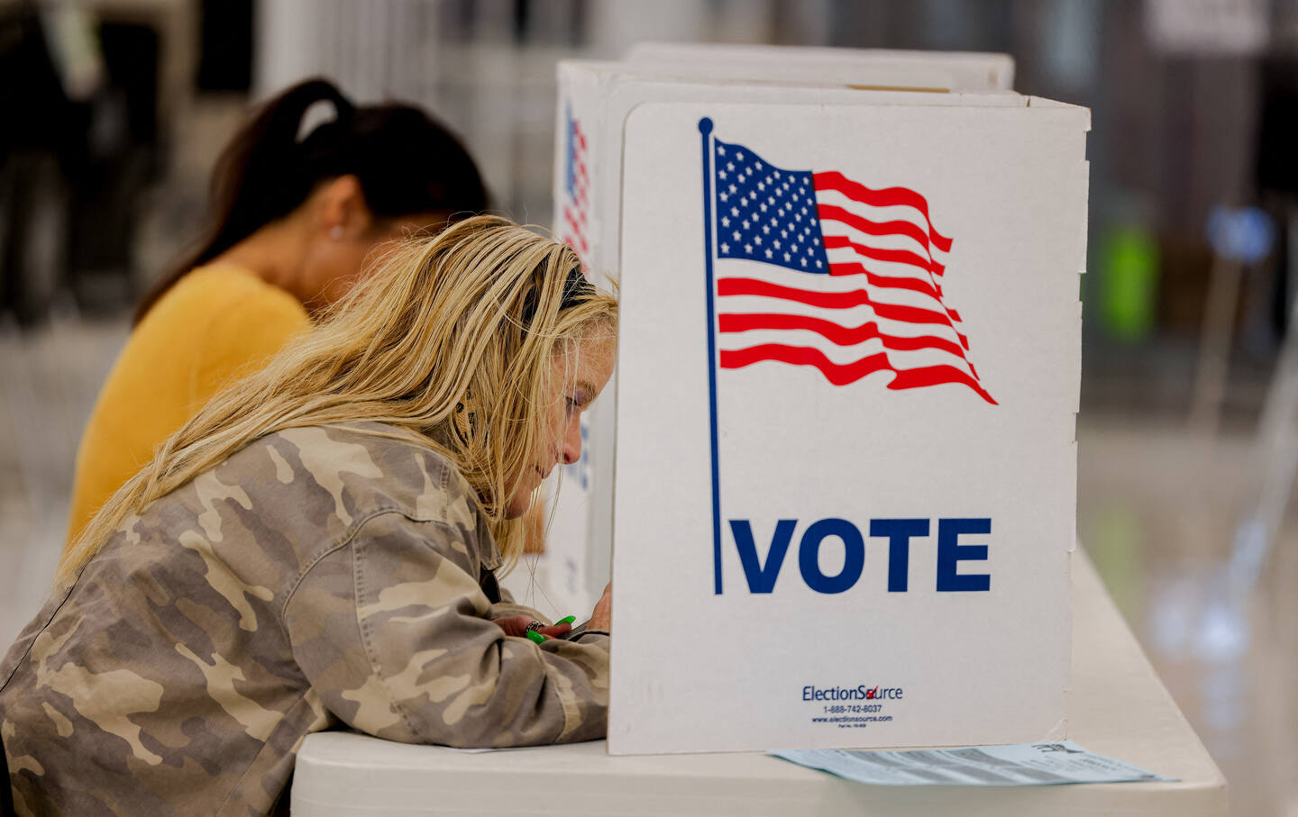 A woman completes her ballot at a polling booth in Fairfax on November 5, 2024.