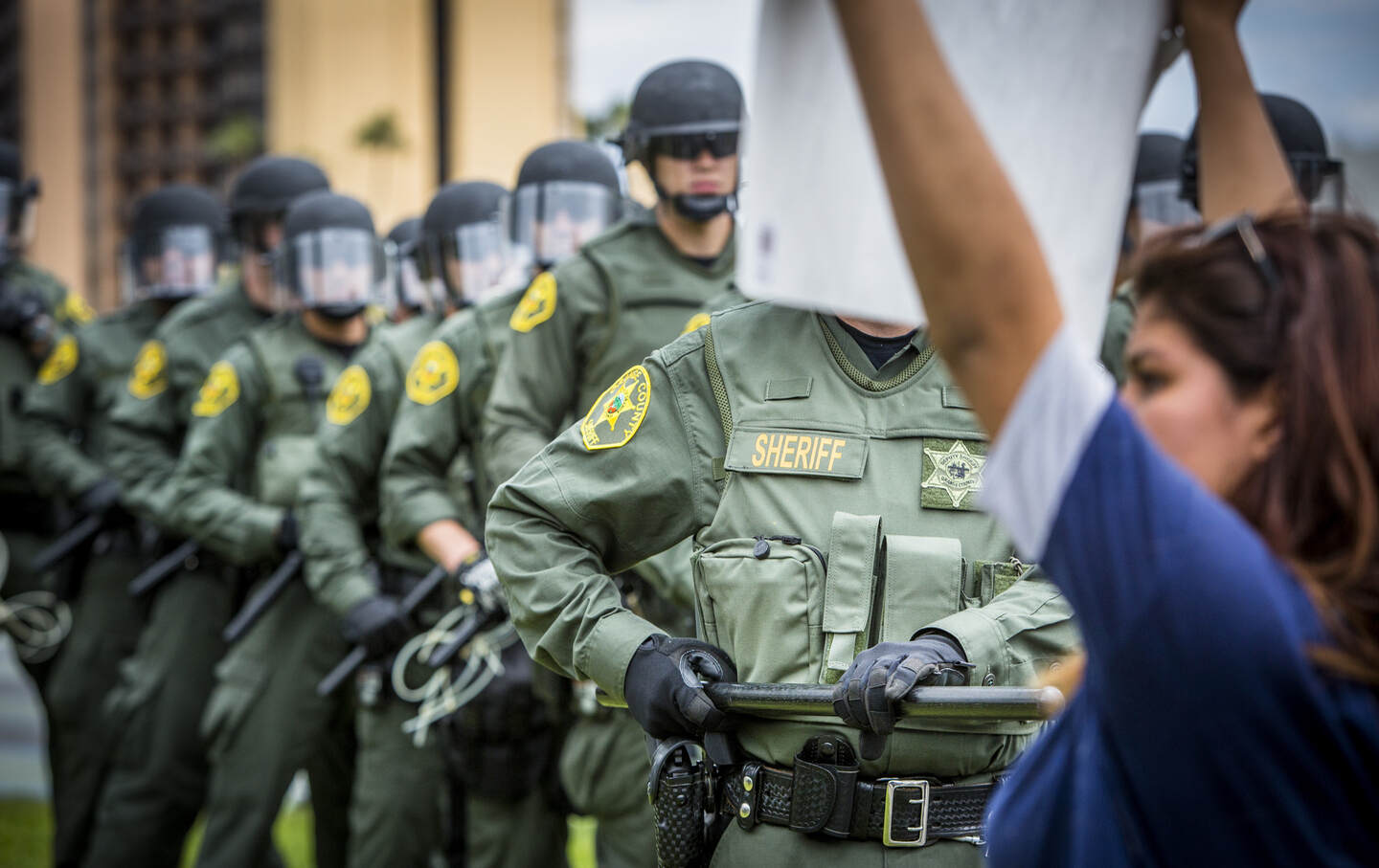 Police confront protesters at a Donald Trump rally.