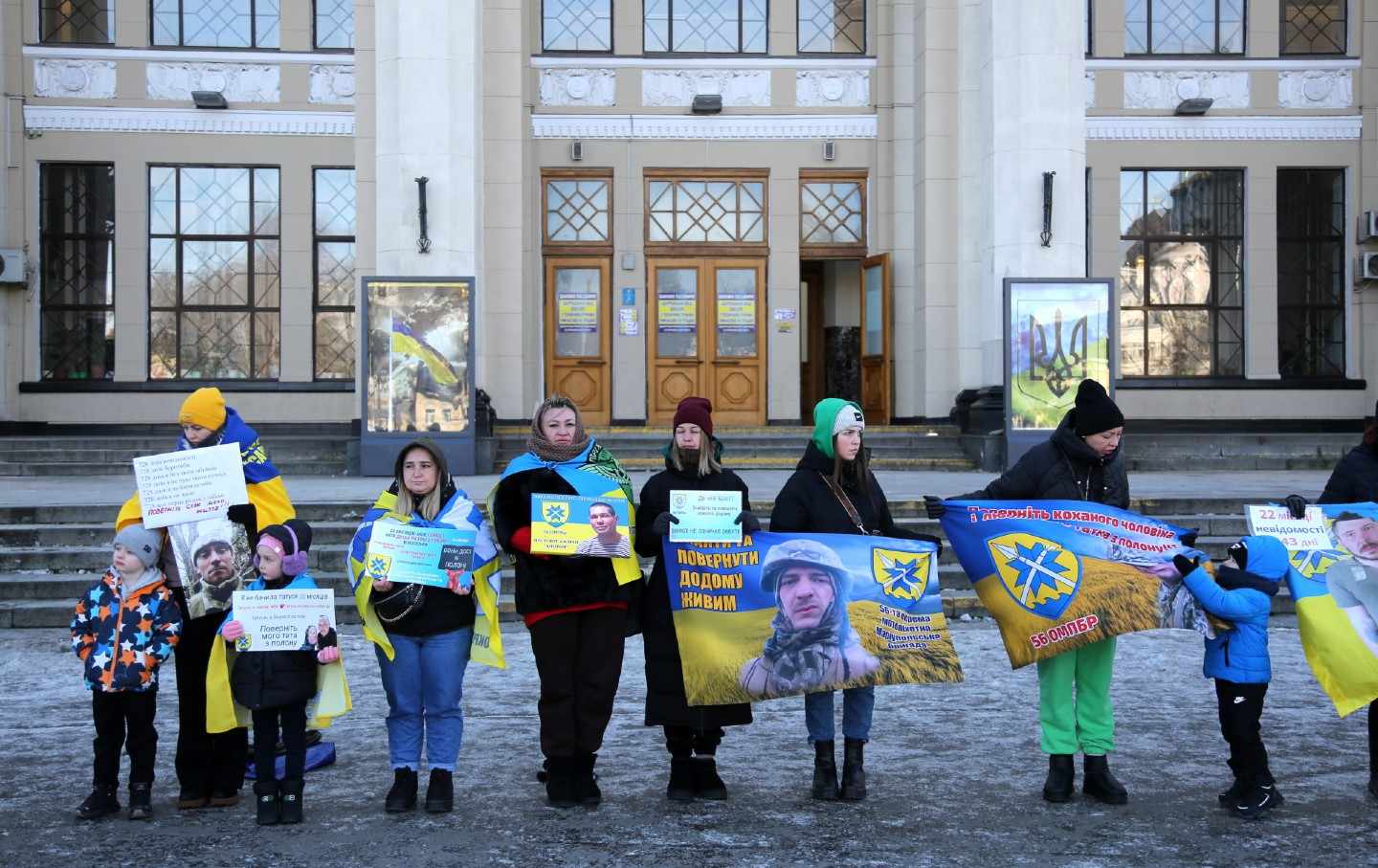 People hold banners during a rally in support of Ukrainian POWs near the railway station on February 16, 2025, in Odesa, Ukraine.