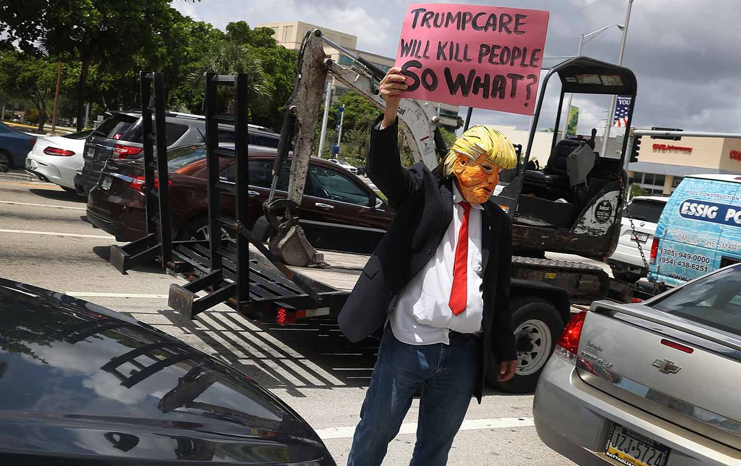 A man protests Trump’s effort to strangle the Affordable Care Act in 2017.