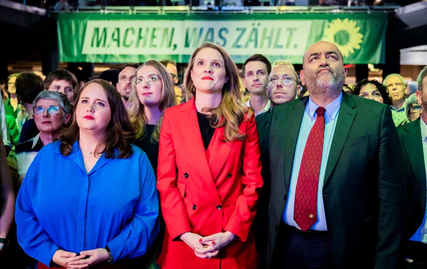 From left to right, Ricarda Lang, a federal chairperson of Bündnis 90/Die Grünen; Terry Reintke, the Greens' lead candidate for the 2024 European elections; and Omid Nouripour, a federal Chairperson of Bündnis 90/Die Grünen, react to the first projections at the Greens' election party in the Columbiahalle in Berlin.