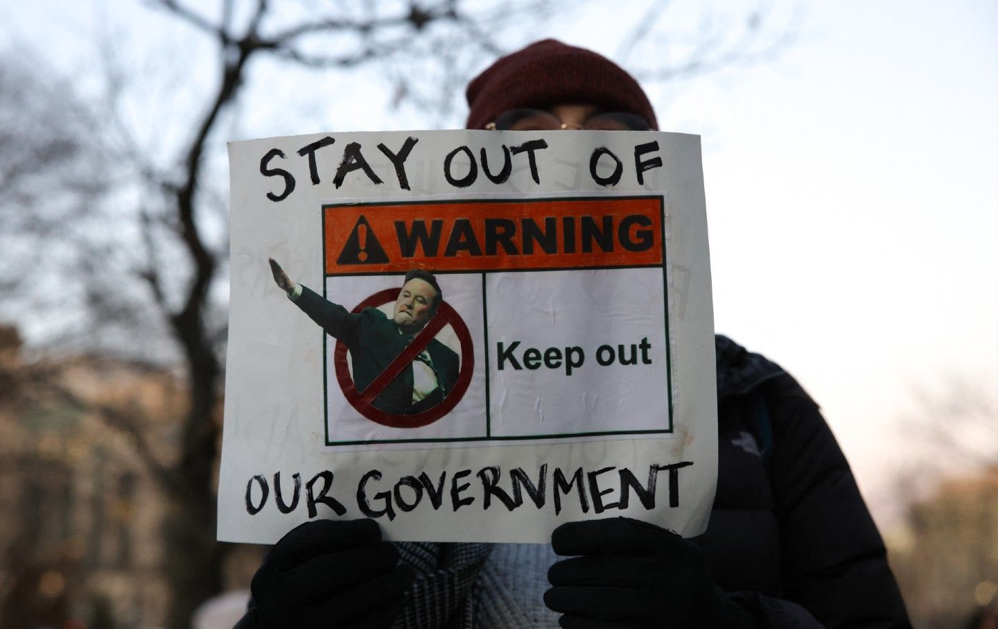 Demonstrators protest federal layoffs and demand the termination of Elon Musk from the Department of Government Efficiency (DOGE) in Washington, DC, on February 7, 2025.