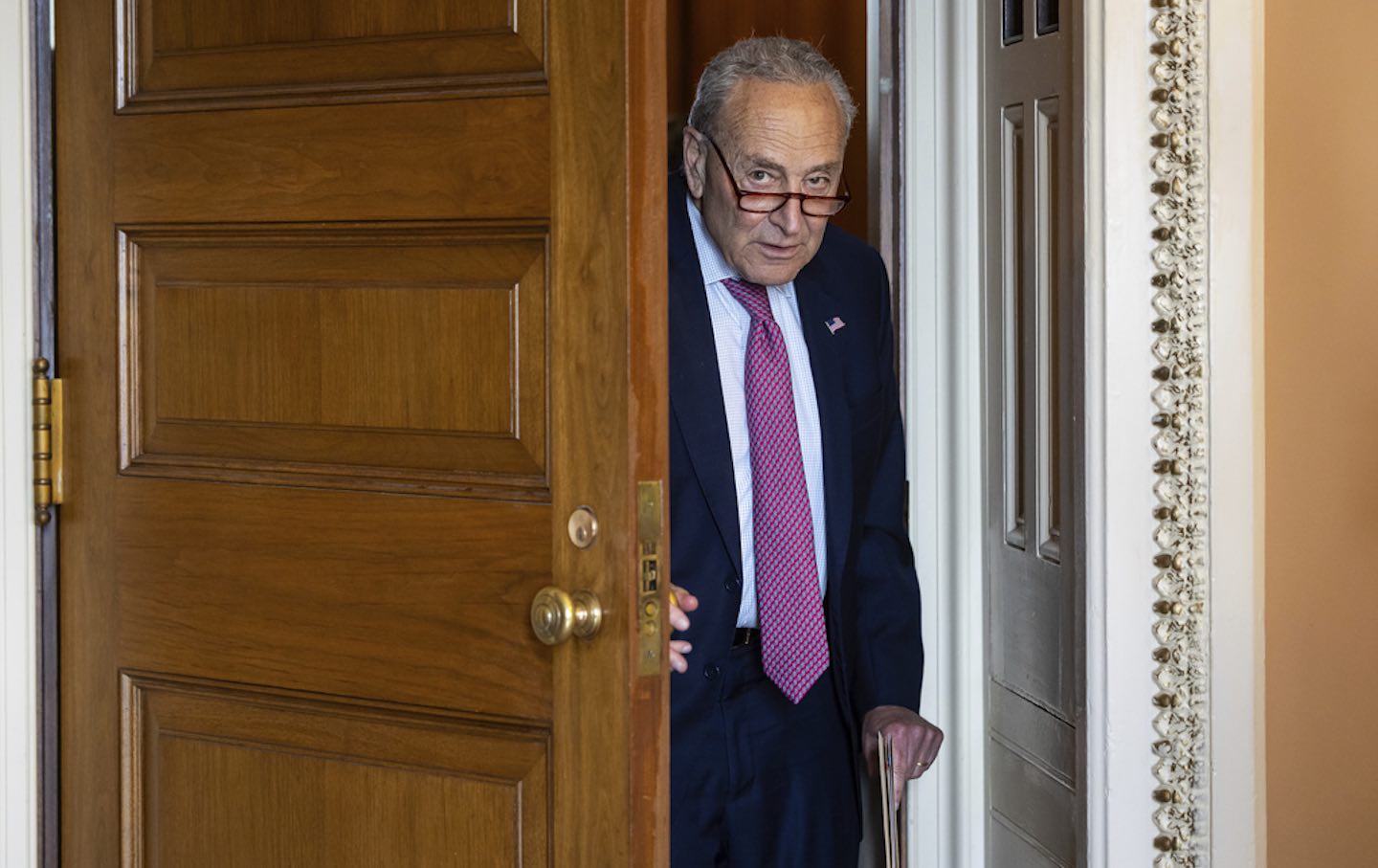 Chuck Schumer coming through a doorway