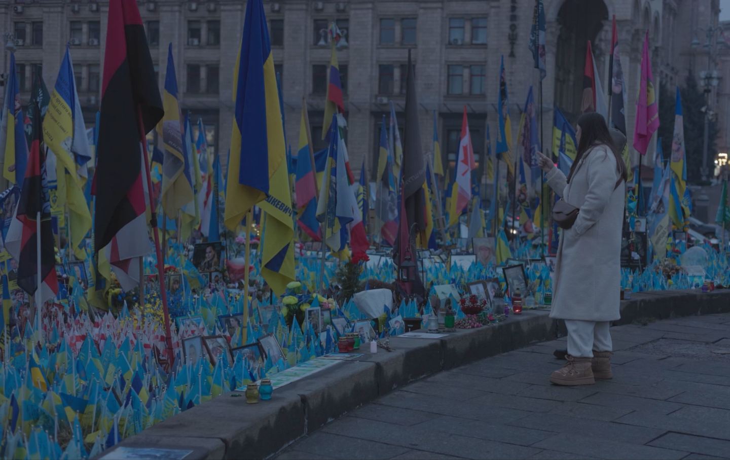 A woman visits a memorial for fallen soldiers at at Kyiv’s Maidan, or Independence Square, on Saturday, March 1.