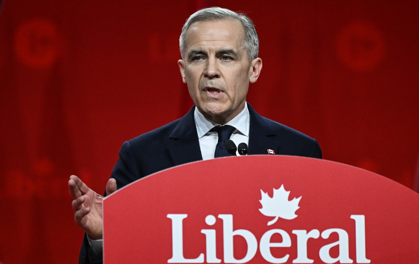 Mark Carney stands at a Liberal Party of Canada podium.