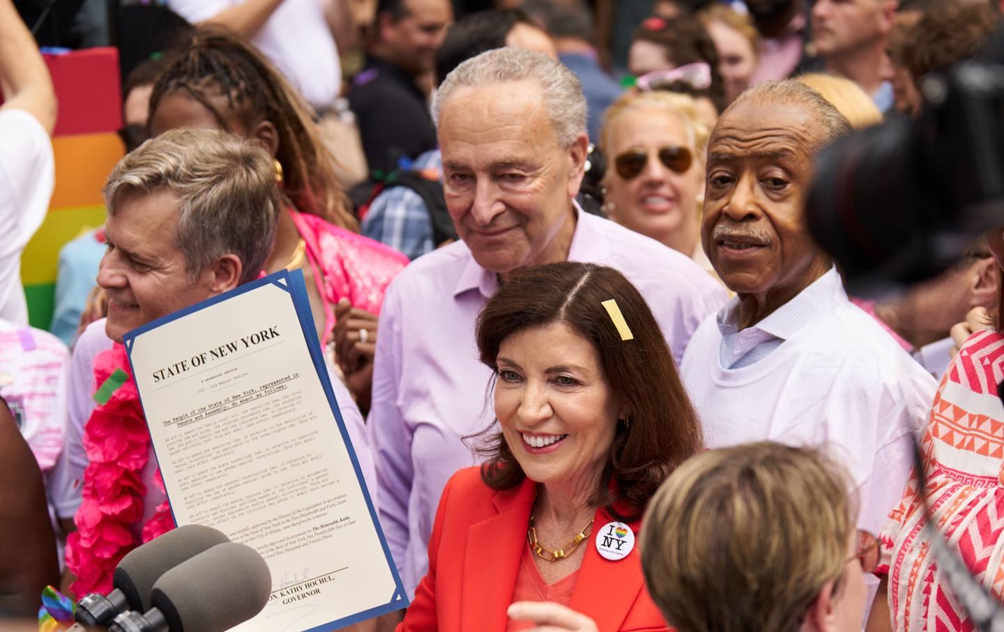 Kathy Hochul, center, governor of New York, center, displays signed legislation designating New York State as a safe haven for trans youth and physicians before the NYC Pride March in New York, US, on Sunday, June 25, 2023.