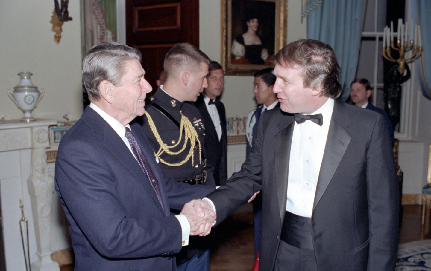 President Ronald Reagan shakes hands with Donald Trump in a reception line in the White House's Blue Room, Washington, DC. November 3, 1987.