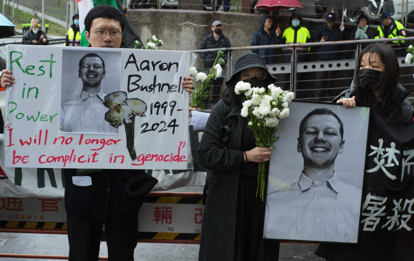 During a protest against US policies regarding Israel and Palestine outside the American Institute in Taiwan in Taipei on March 7, 2024, demonstrators from the Taiwan Action Front for Palestine display portraits of Aaron Bushnell, a 25-year-old active-duty member of the US Air Force who set himself on fire outside the Israeli Embassy in Washington, DC.