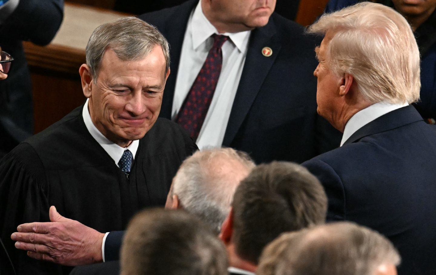 Donald Trump greets US Supreme Court Chief Justice John Roberts on his way to address a joint session of Congress on March 4, 2025.