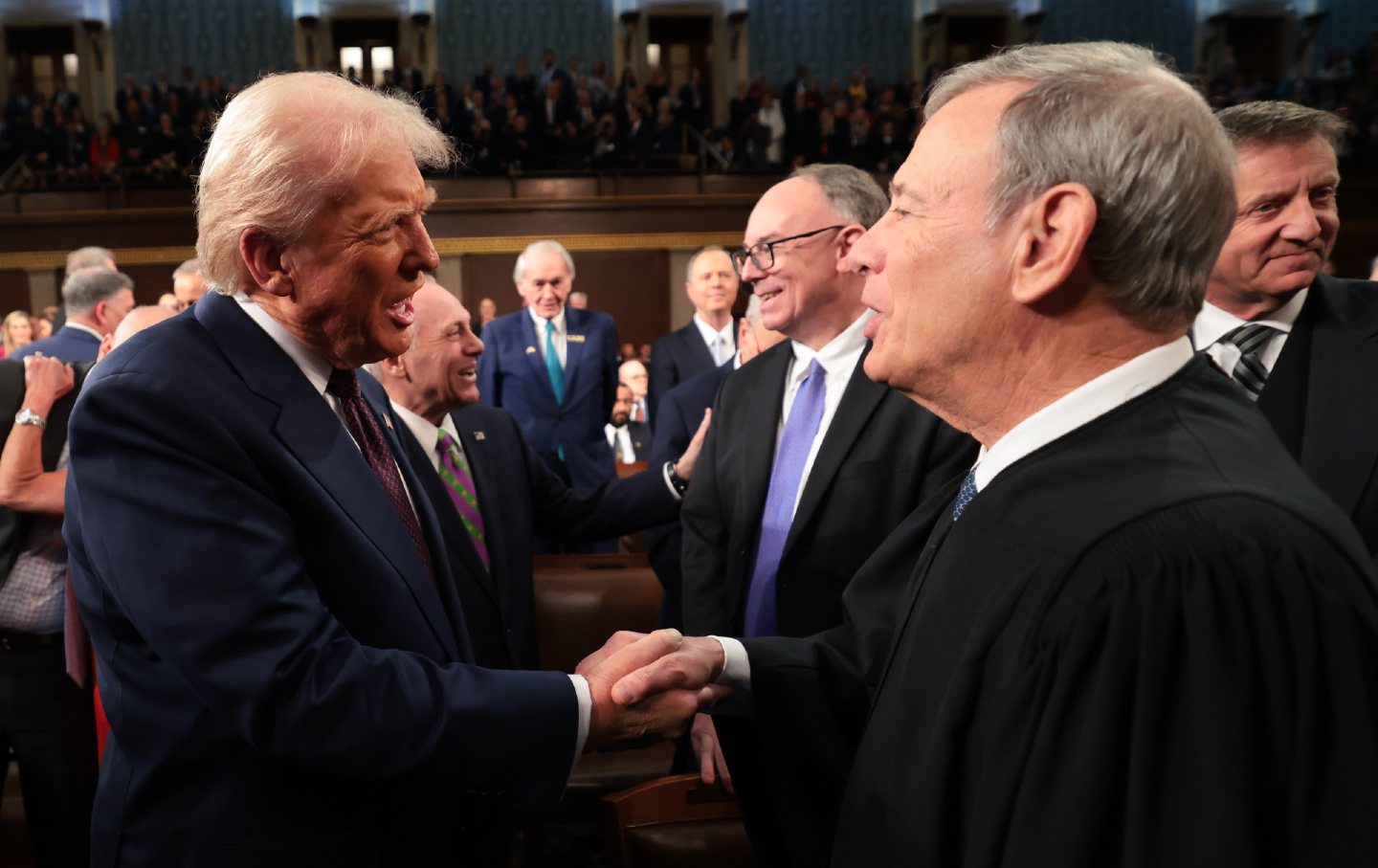 Donald Trump greets Chief Justice John Roberts as he arrives to deliver an address to a joint session of Congress at the US Capitol on March 4, 2025.