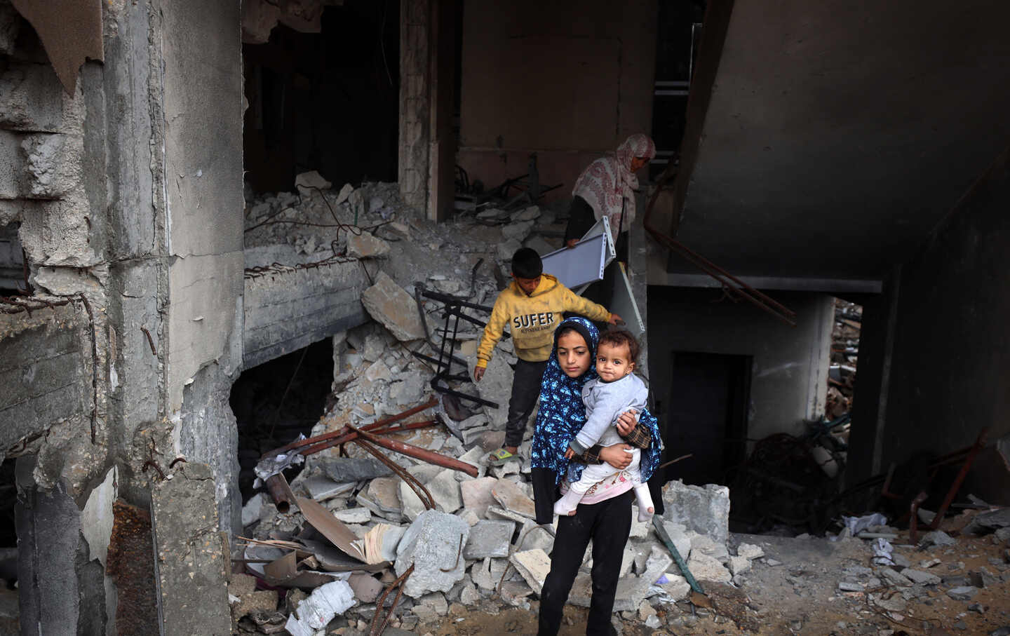 Palestinian evacuees from Beit Hanoun, in the north of the Gaza Strip, seek refuge at the Islamic University, which was previously bombed, to stay inside following Israeli evacuation orders in Gaza City on March 21, 2025.