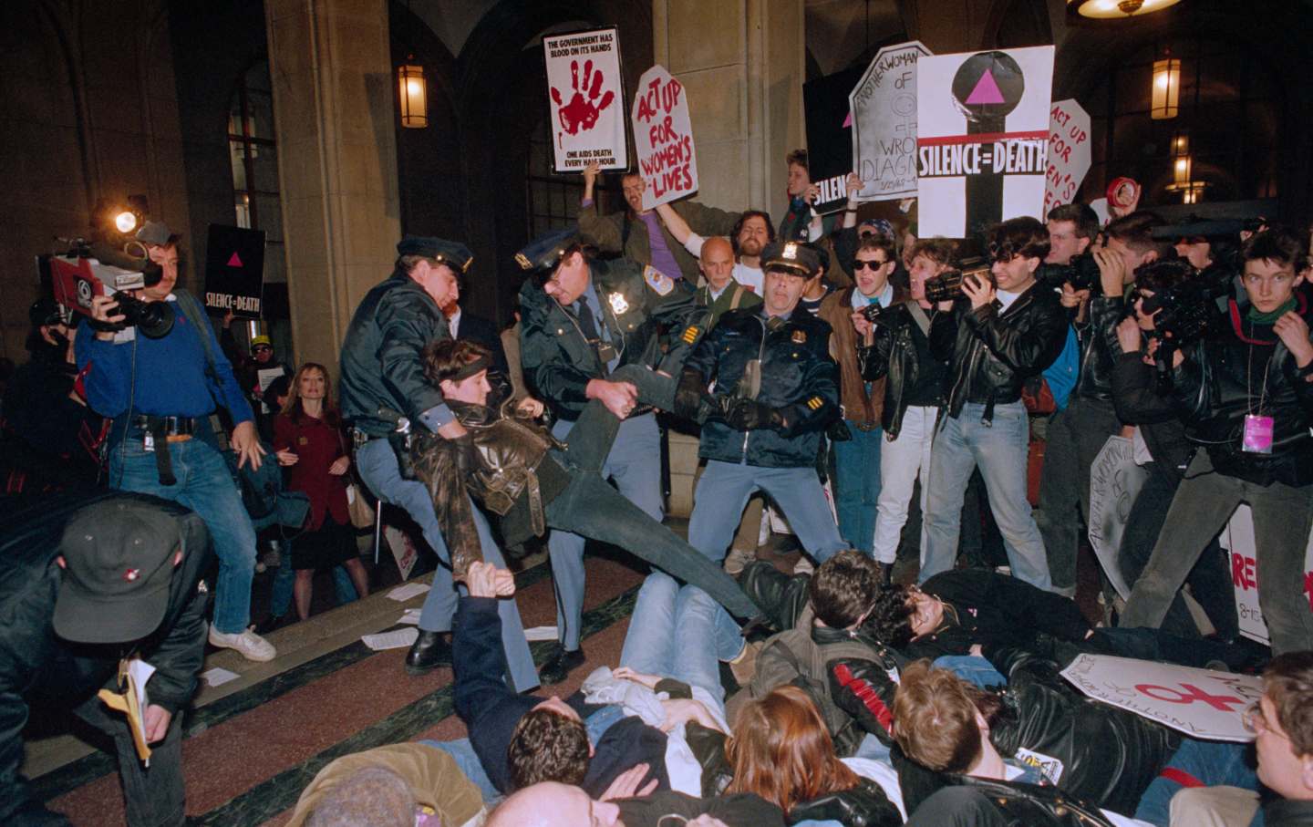 Police officers remove members of Act-Up, who have staged a sit-in inside the hallway of the New York State Capitol in Albany.