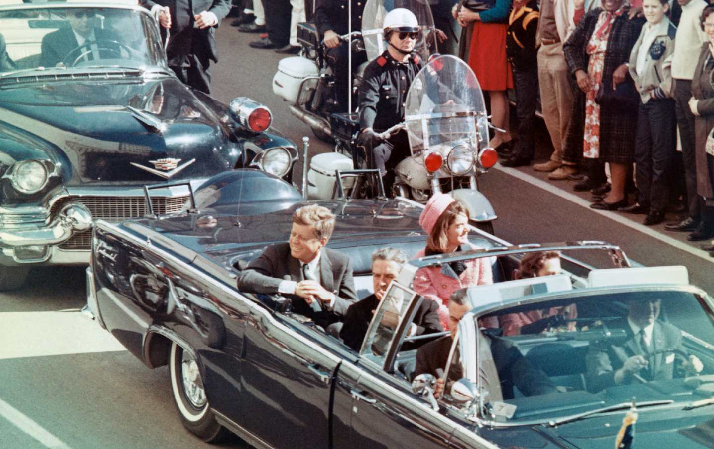 JKF riding in a car through a parade.