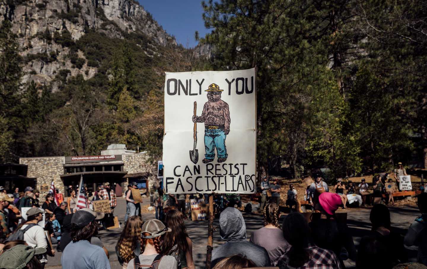 Protesters hold signs during a national day of action against Trump administration's mass firing of National Park Service employees at Yosemite National Park, California, on March 1, 2025.